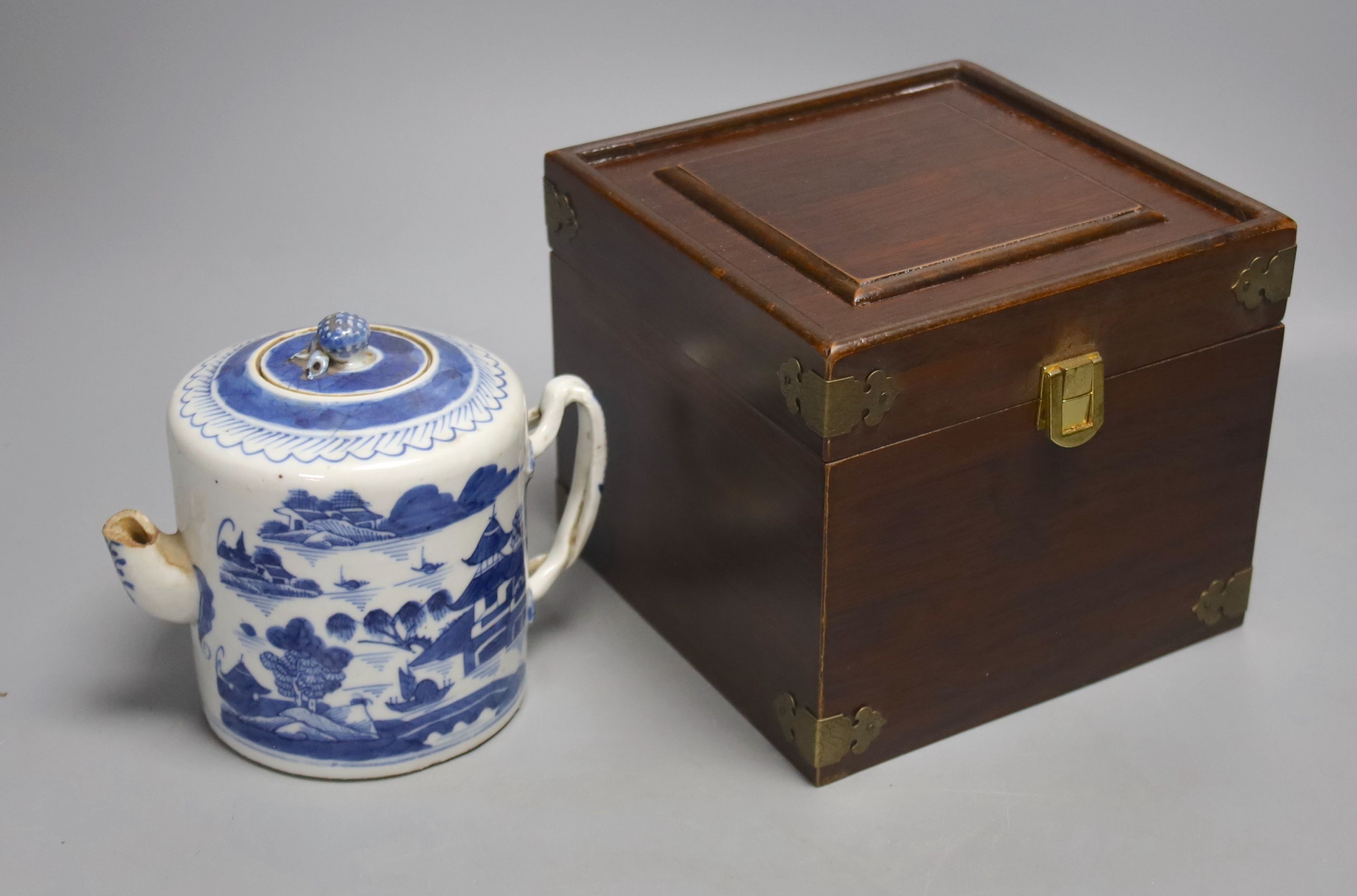 A Chinese Yixing teapot, similar blue and white teapot, blue and white dish and a candle holder, blue and white tea pot 14 cms high.